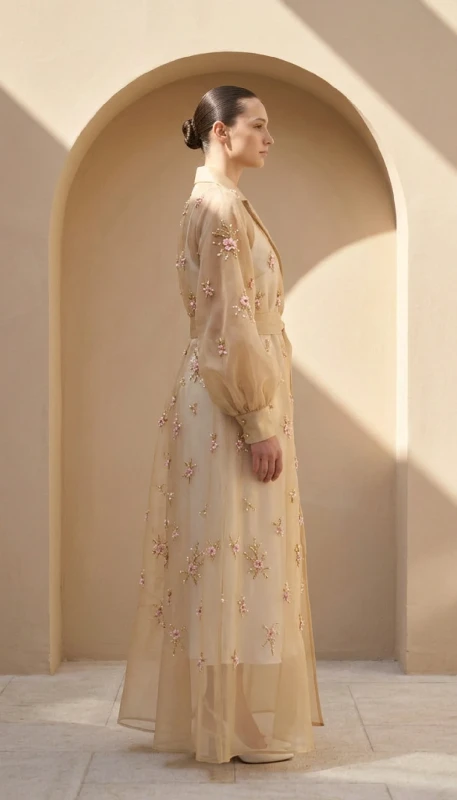 Side view of elegant embroidered open abaya in champagne chiffon with bishop sleeves and floral beadwork